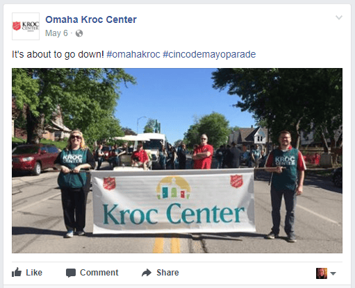 Jennifer Bull carrying a Kroc Center banner with staff and volunteers during Omaha’s Cinco de Mayo parade.