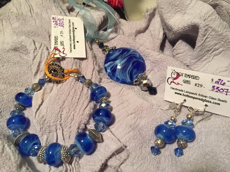 Handmade glass beaded jewelry in swirls of blue, set of bracelet, pendant and earrings.